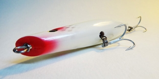http://www.fishingreportsnow.com/images/product.reviews.2013/Guppy.Lure.Company.Pencil.Popper.Bottom.JPG